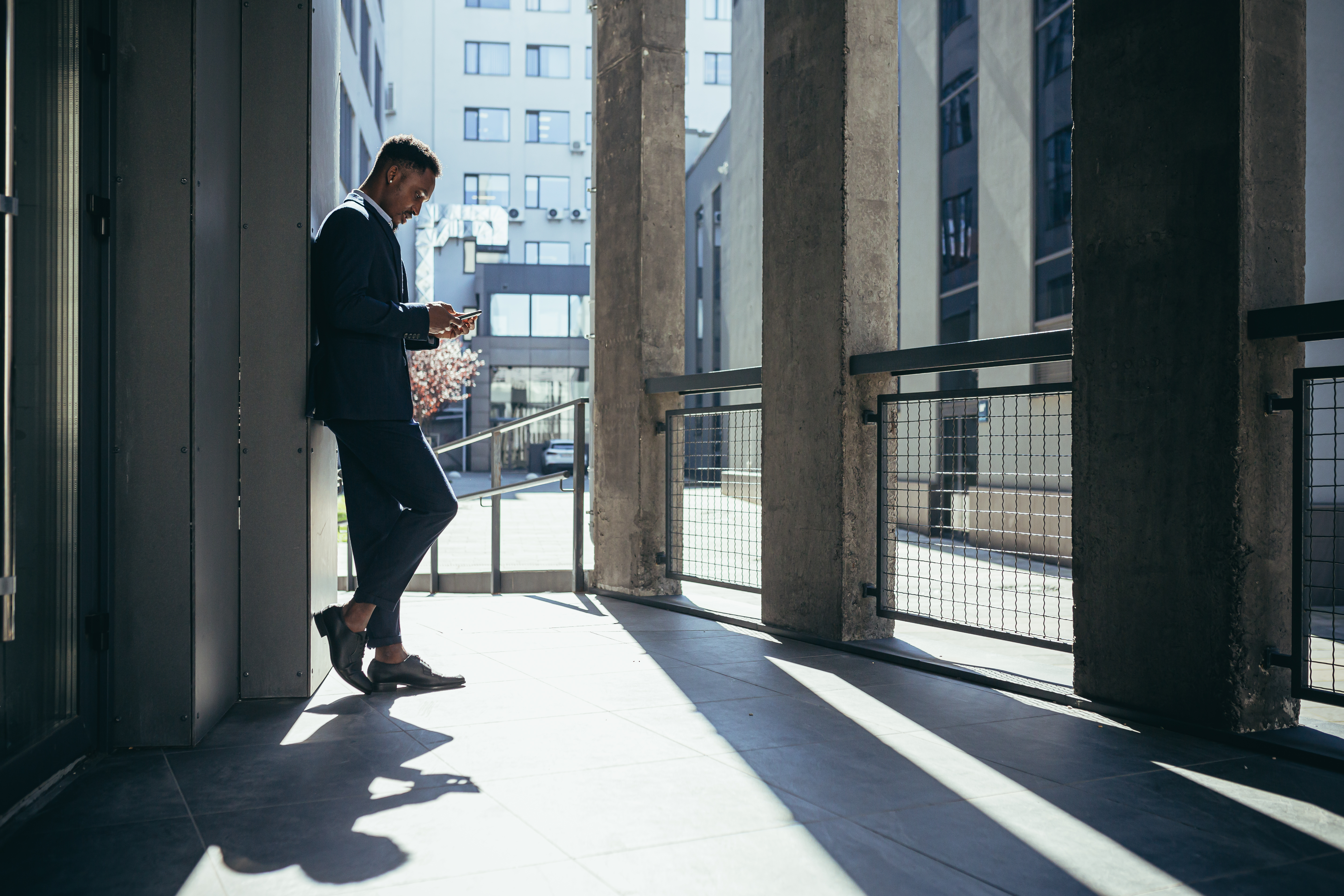 A professional pausing in a sunlit colonnade — the considered judgment behind every tool we share.